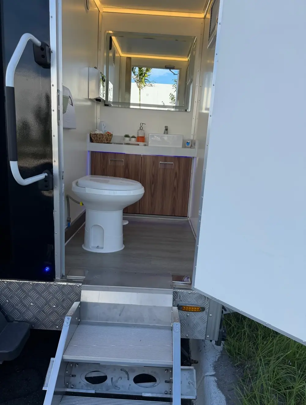 Vanity, sink and soap inside a luxury restroom trailer