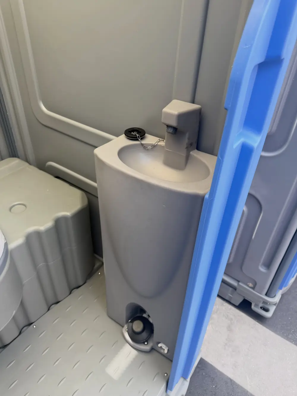 Clean portable toilet interior with urinal for a campsite