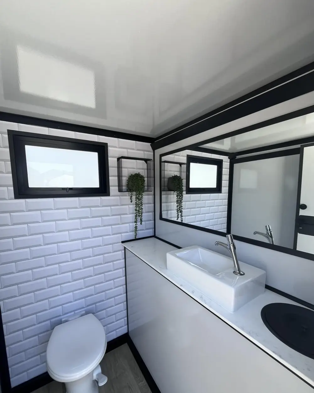 Bright trailer stall with tile walls and mirror